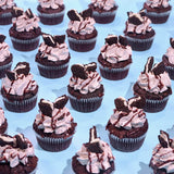 Oreo Cupcakes with chocolate sponge, Oreo cream frosting, ganache drizzle, and Oreo cookie pieces by Crumbs & Doilies.